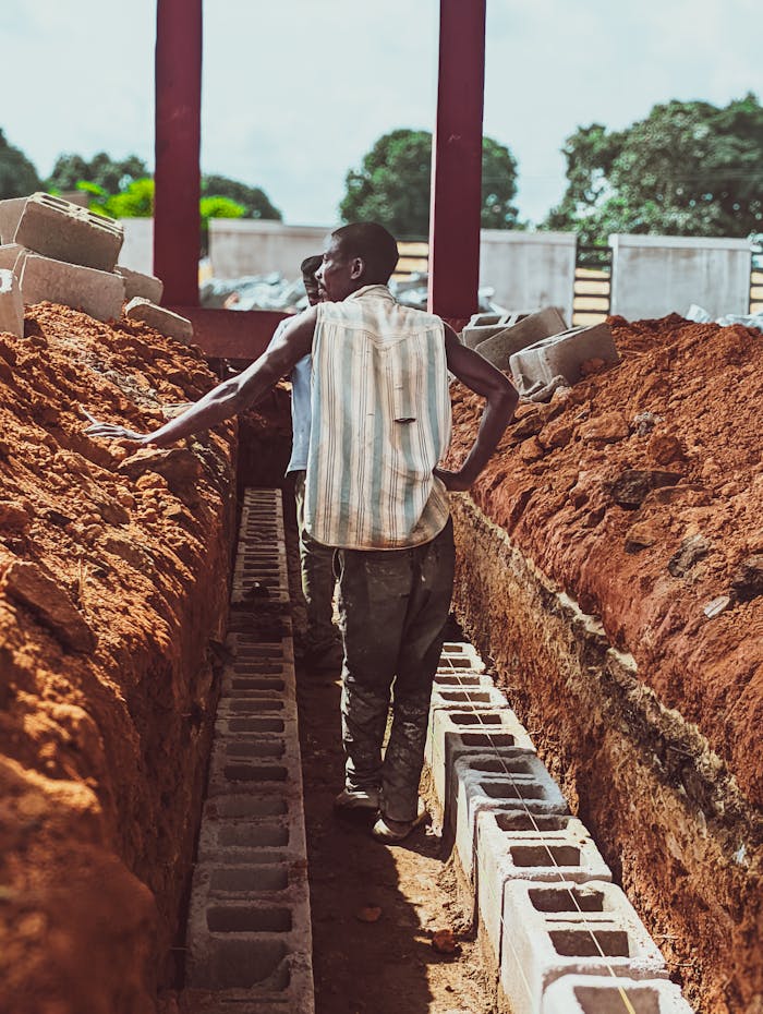 Home Workers on a construction site laying foundation bricks in Kaduna, Nigeria.